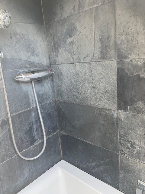 Limescale removal from shower room fixtures to prevent hard water damage